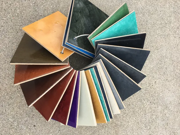 A fan deck of coating color chips opened in a circle across the full color range