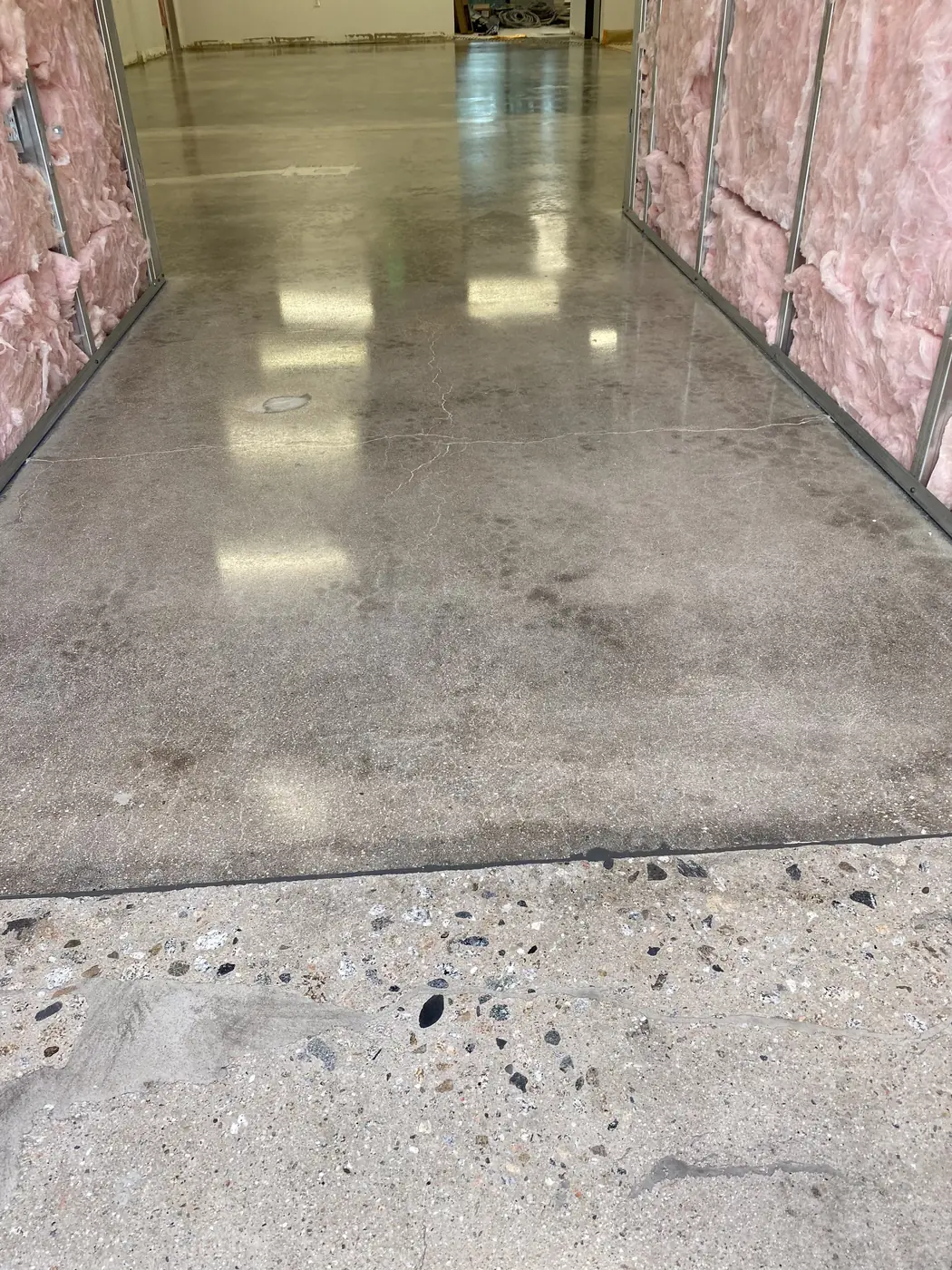 Bare concrete floor ground clean in a room lined with insulation