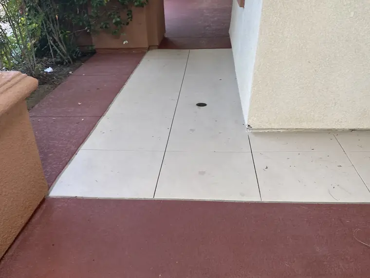 Resurfaced clubhouse walkway in cream with a deep red border band