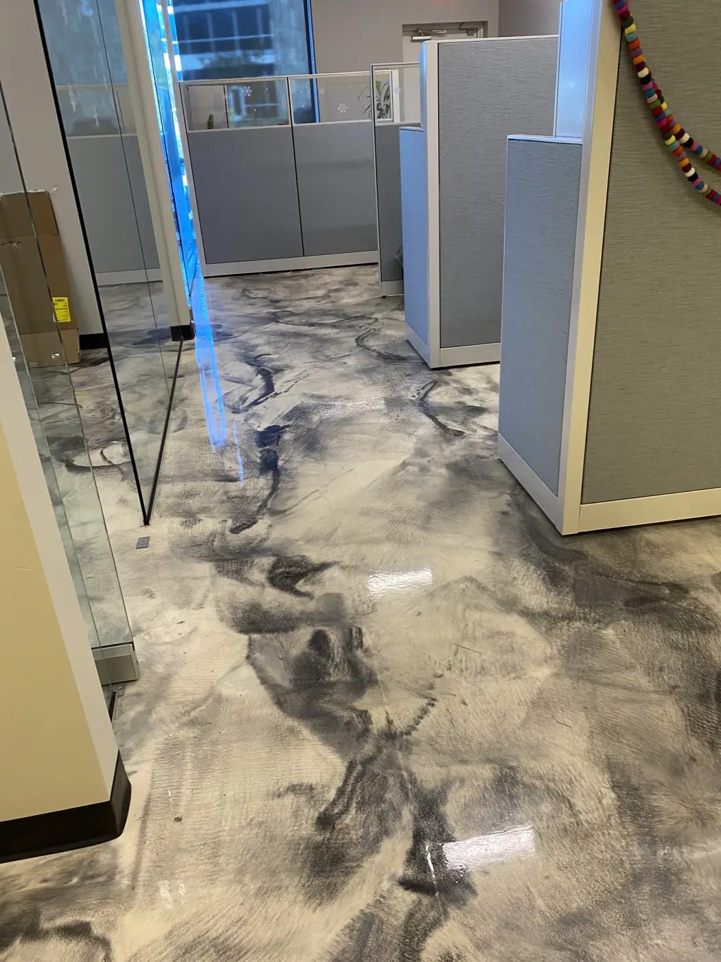 Gray metallic epoxy floor in an open-plan office bay