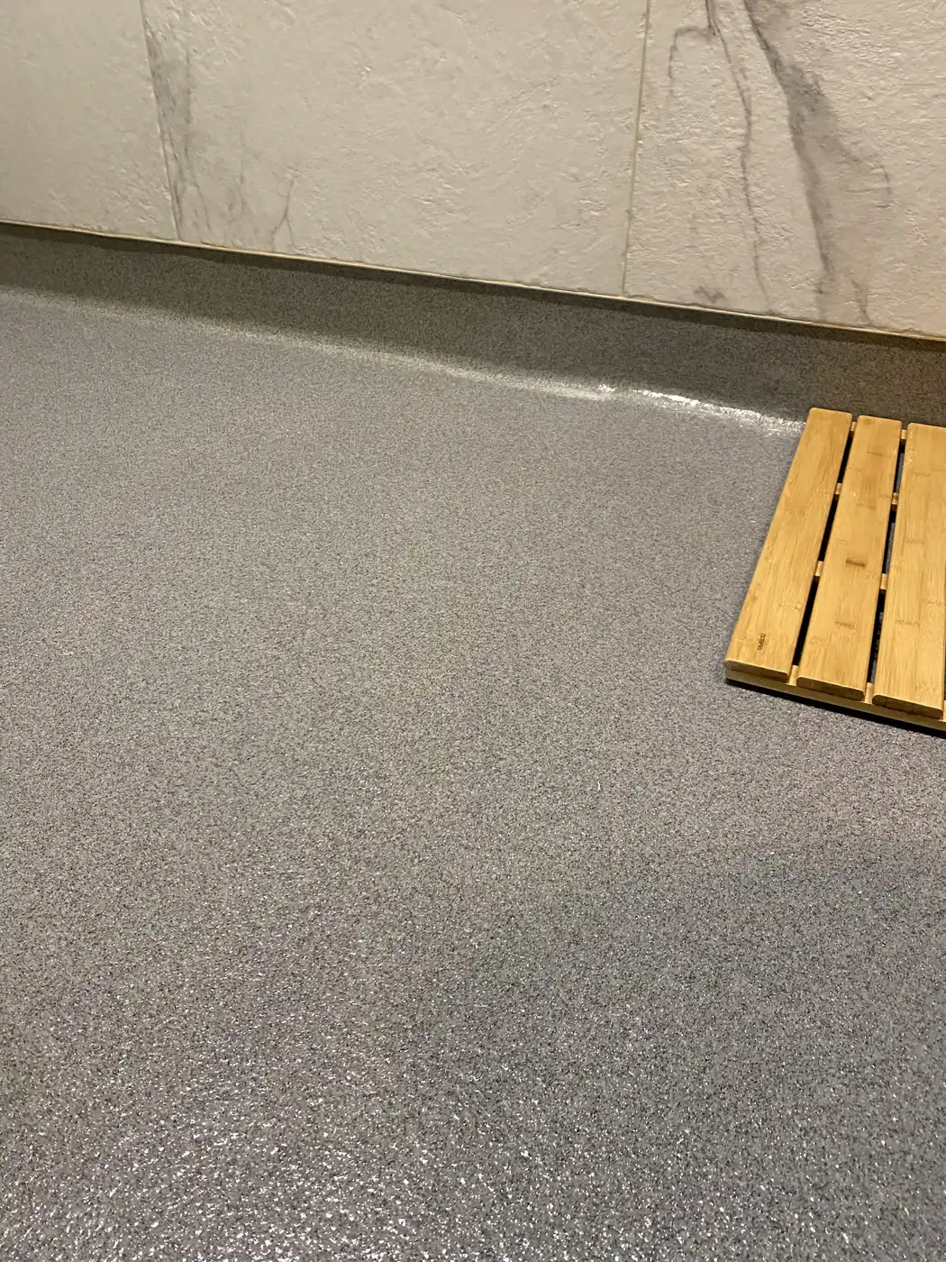 Gray flake epoxy floor beside a stacked timber pallet