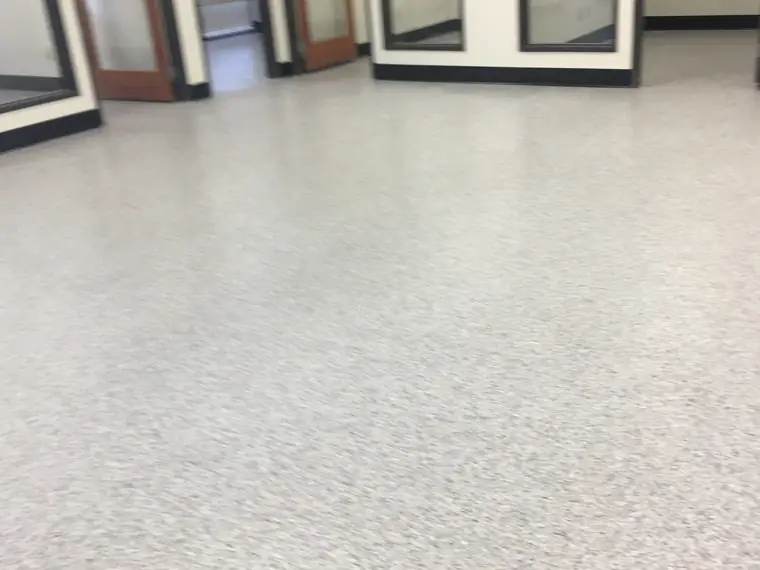 Light gray flake epoxy floor in a showroom stacked with window frames