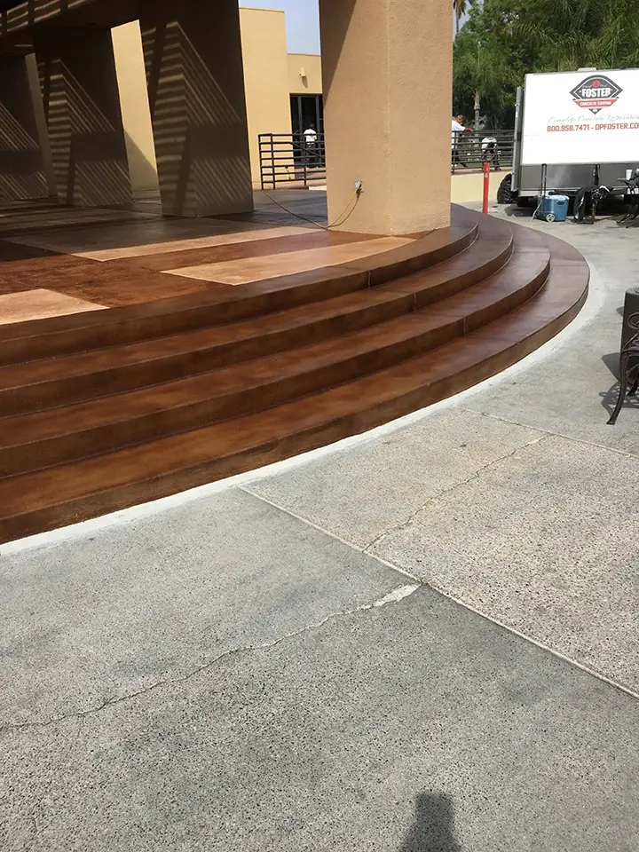 Curved entry steps stained to a wood-plank look