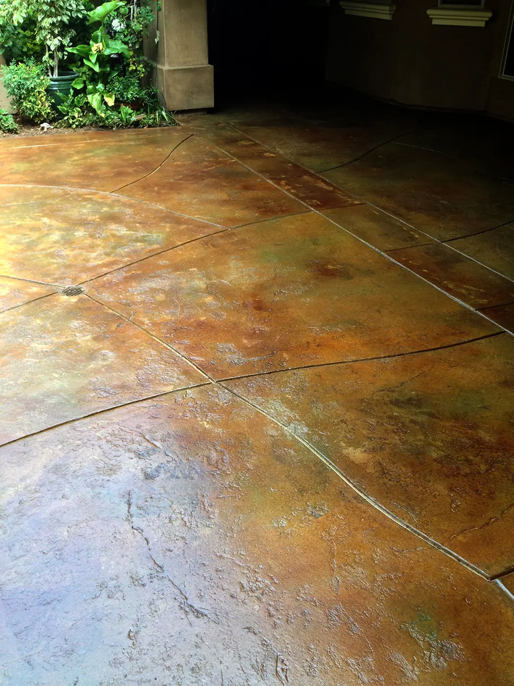 Mottled orange and green acid-stained patio surface