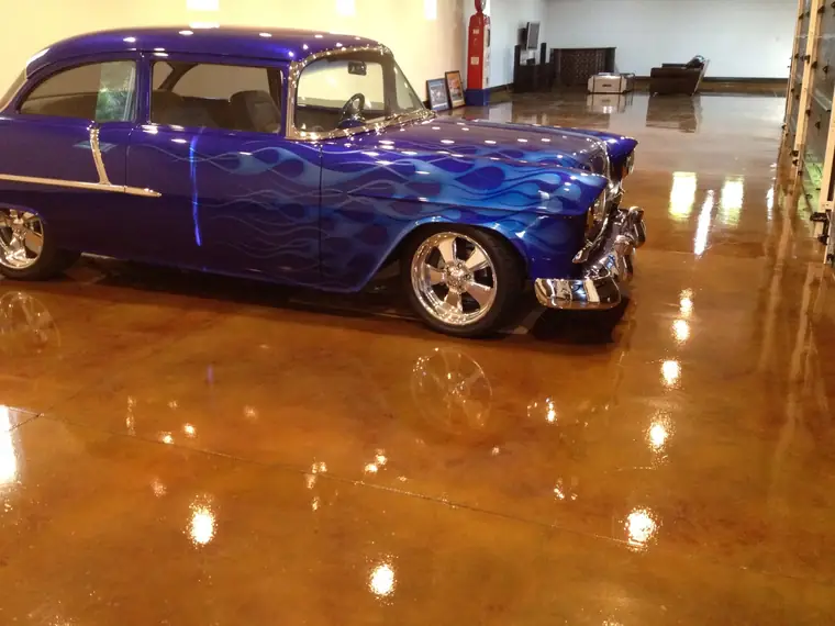 Classic hot rod reflected in a mirror-gloss copper-stained garage floor