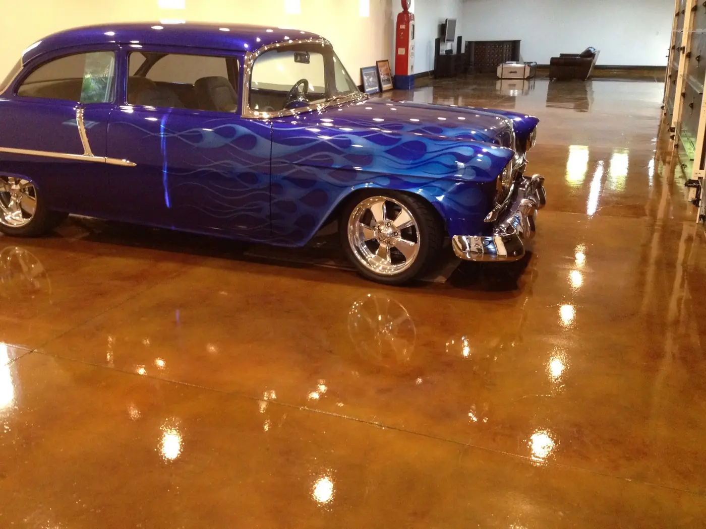 Classic hot rod reflected in a mirror-gloss copper-stained garage floor