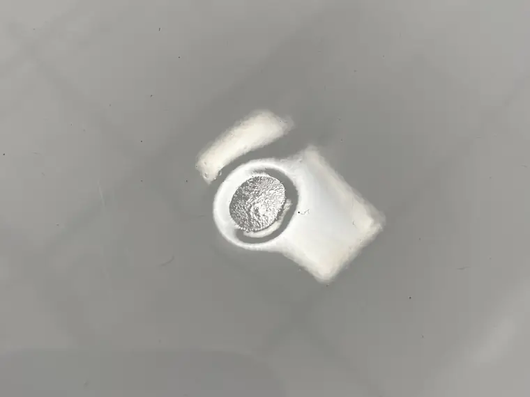 Close view of a floor drain set into a seamless gray epoxy floor