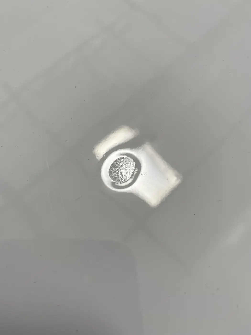 Close view of a floor drain set into a seamless gray epoxy floor