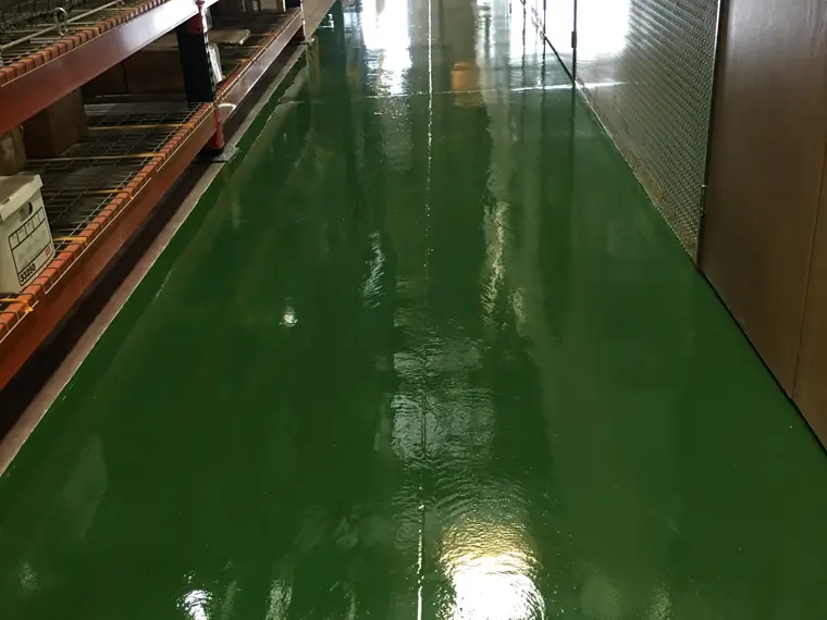 Dark green epoxy aisle running between warehouse racking