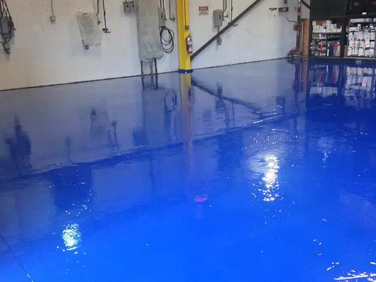 Wet-look blue epoxy floor in an industrial workshop