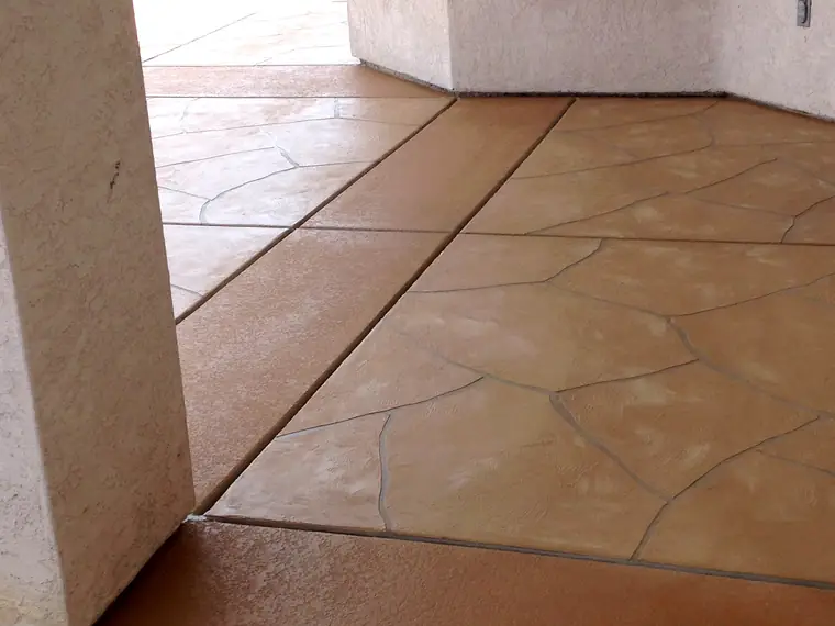 Tan flagstone-pattern microtopping laid over an existing patio slab