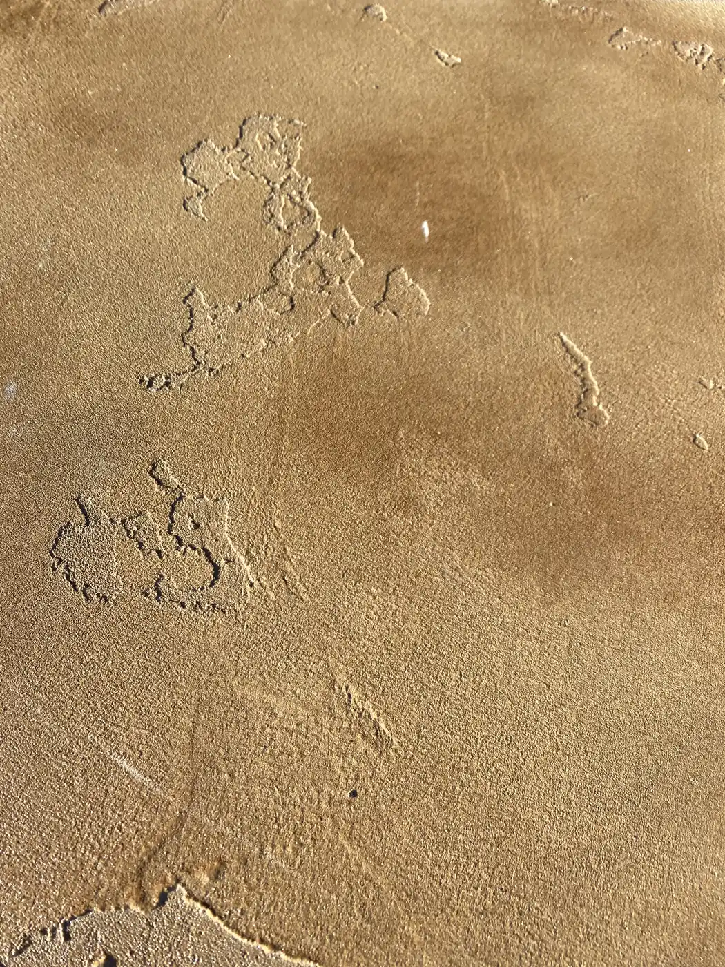 Close view of a trowel-textured tan microtopping surface