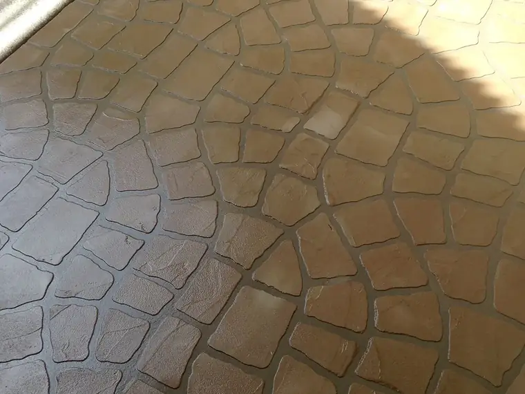 Close view of a stamped stone-pattern overlay in warm terracotta