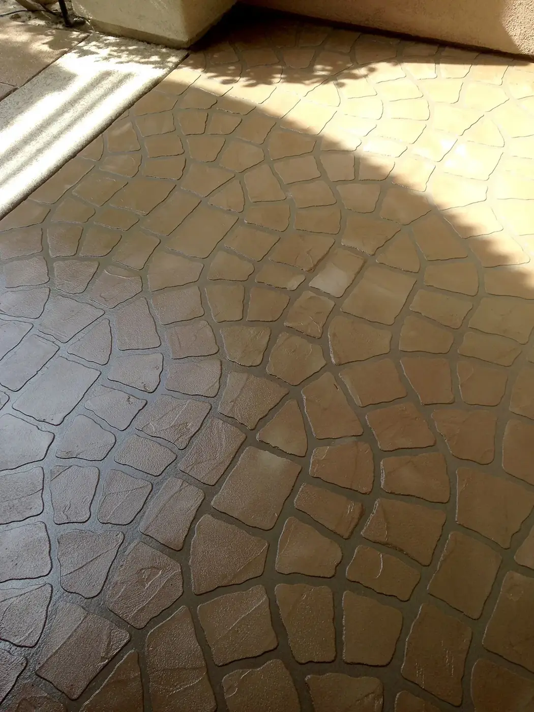 Close view of a stamped stone-pattern overlay in warm terracotta