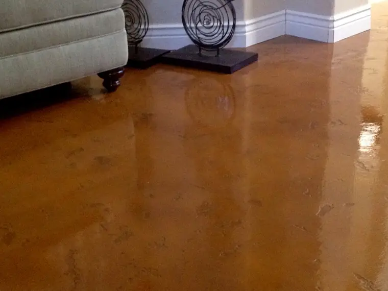Copper stained and polished concrete floor in a furnished living room