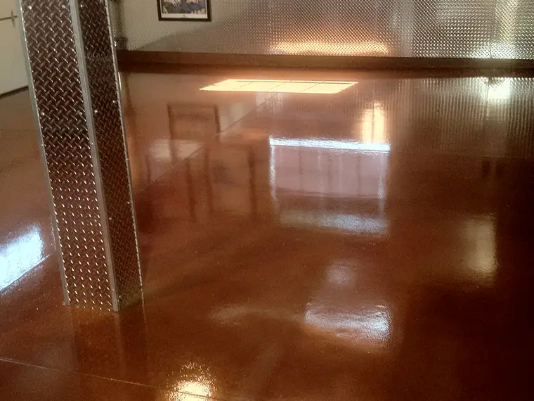 Polished copper stained concrete running down a residential hallway