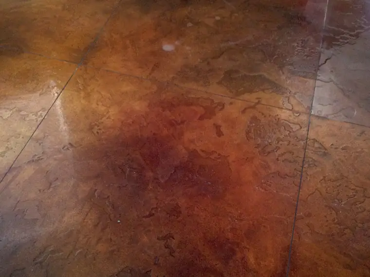 Mottled red and brown acid stained concrete floor