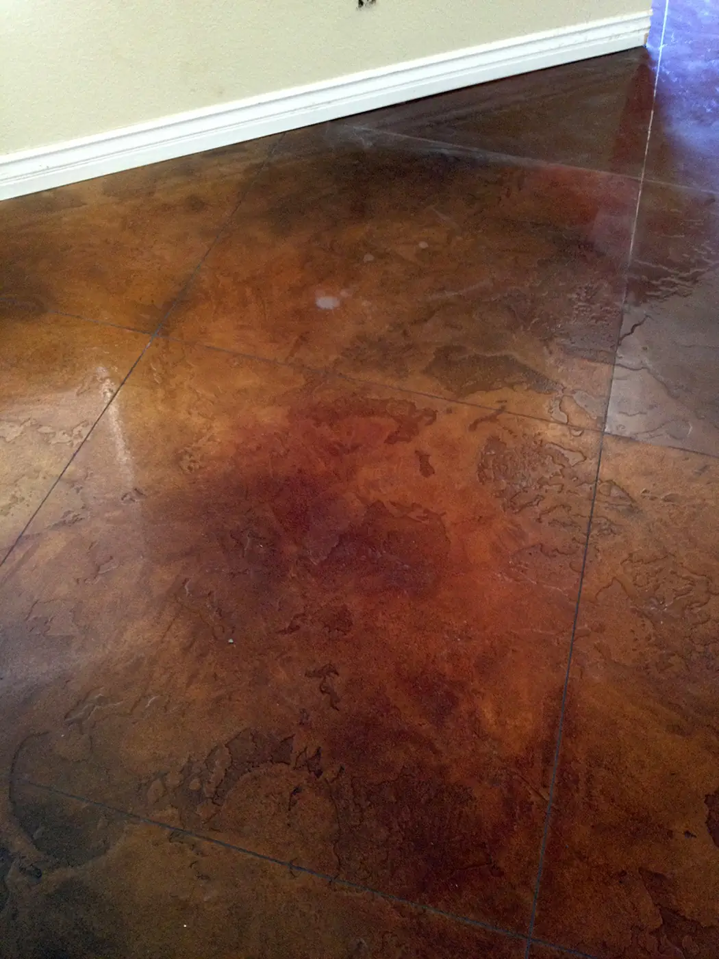 Mottled red and brown acid stained concrete floor