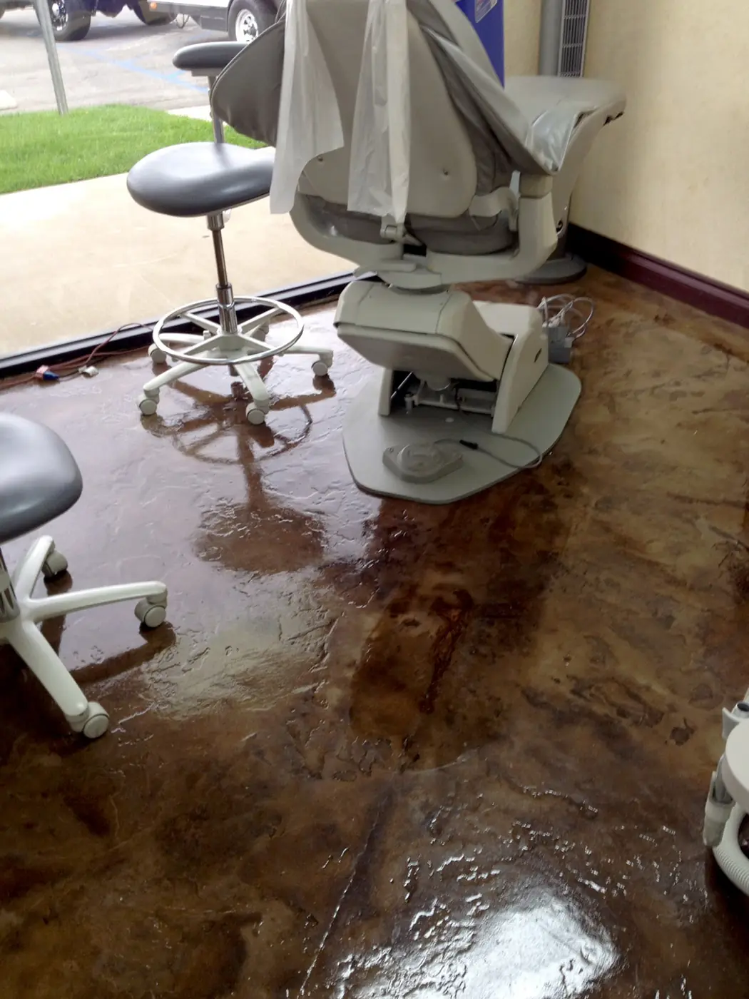 Stained concrete floor in a dental surgery beneath the chair