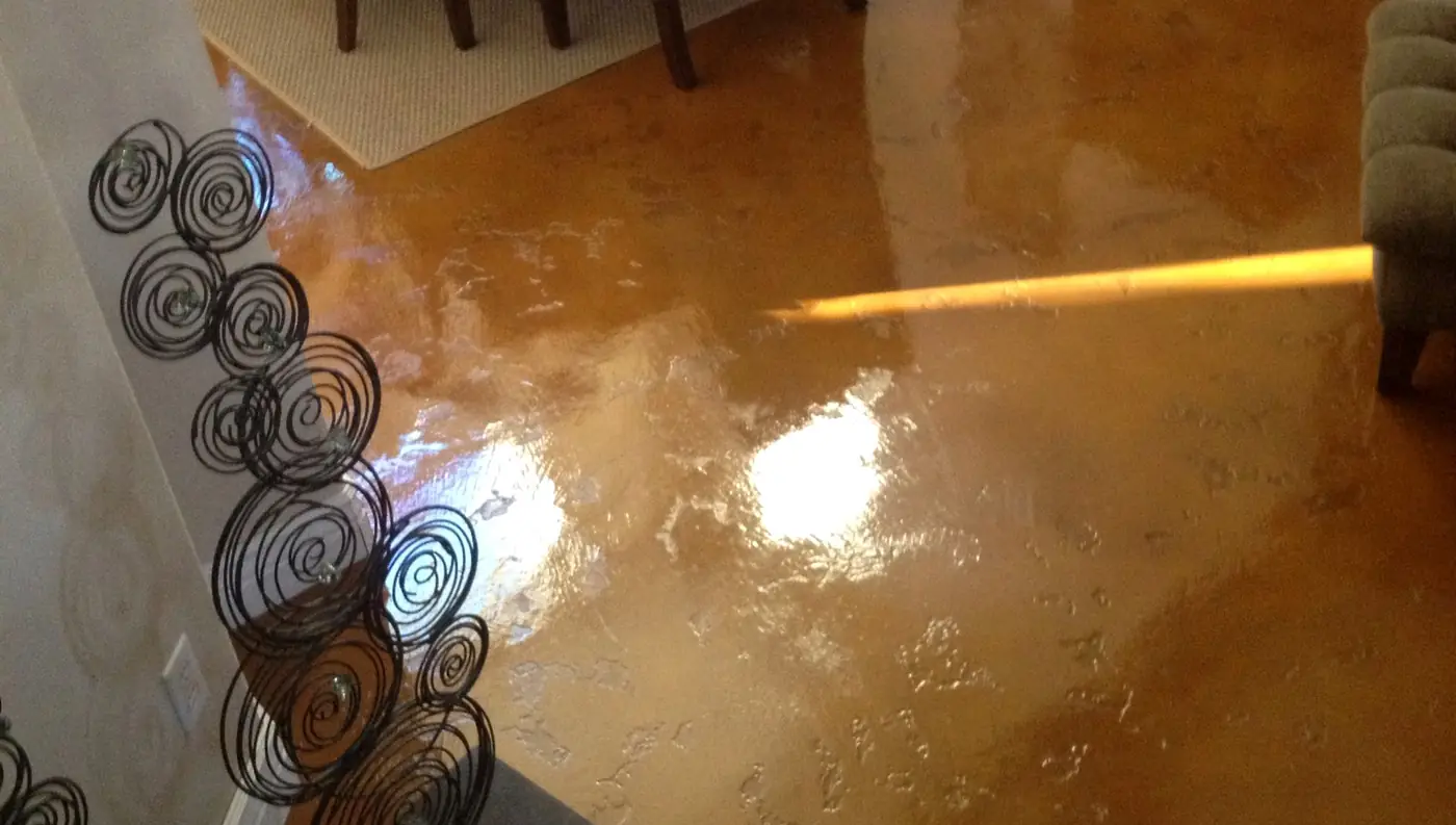 Copper stained interior concrete floor catching the light