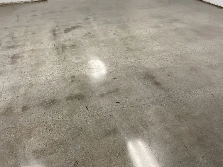 Mottled gray polished concrete floor in an empty commercial space