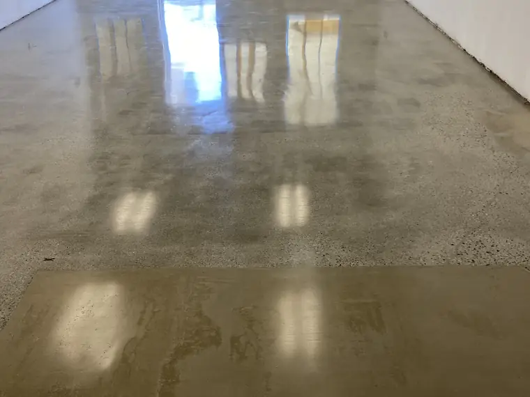 Polished concrete floor running to a glass entrance door