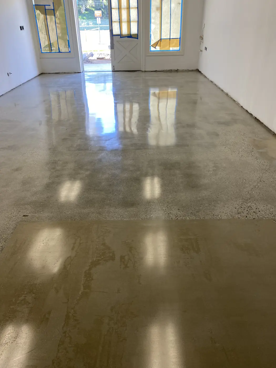 Polished concrete floor running to a glass entrance door