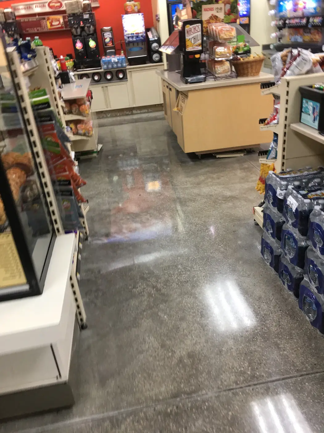 Polished store floor between shelving and the service counter