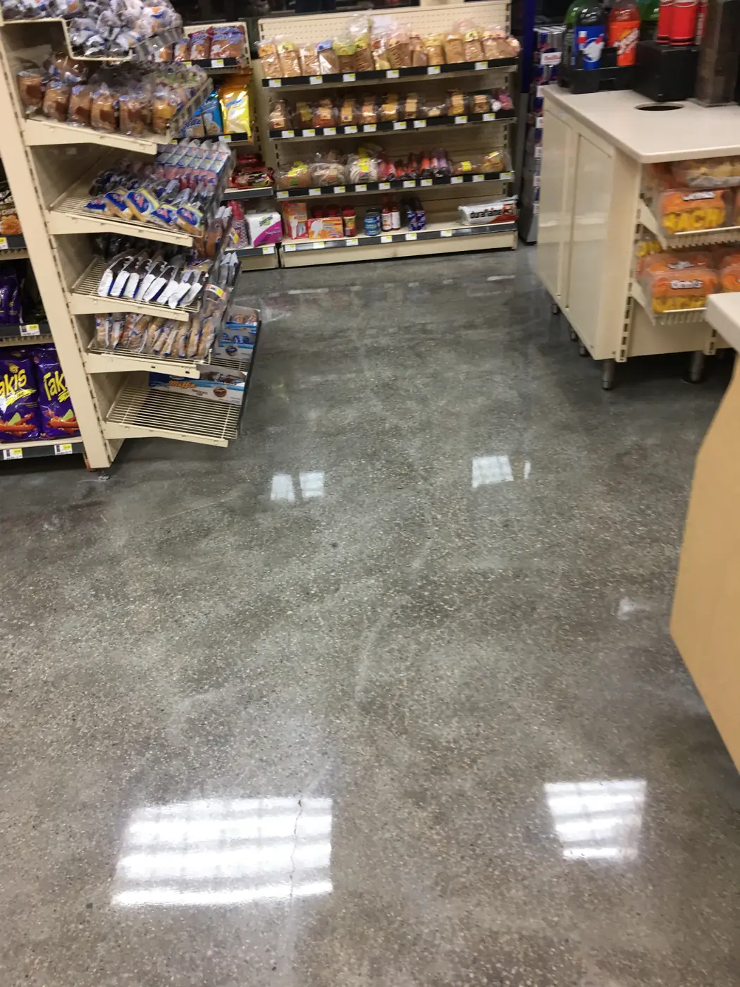 Polished concrete floor running beneath store shelving