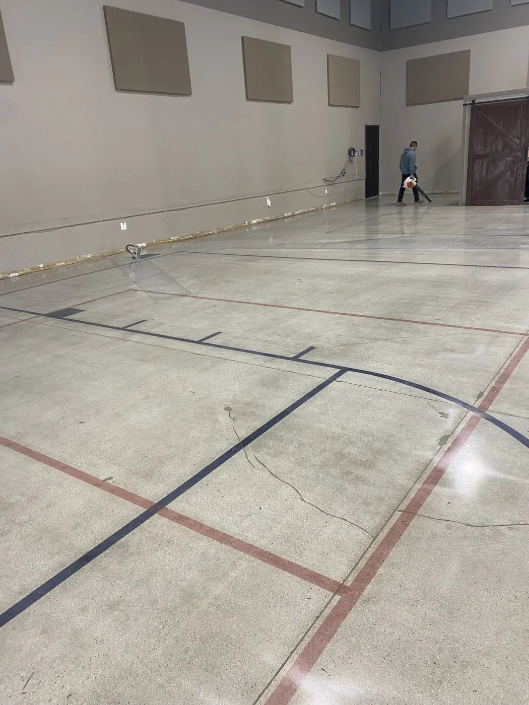 Polished hall floor with red and black saw-cut court lines