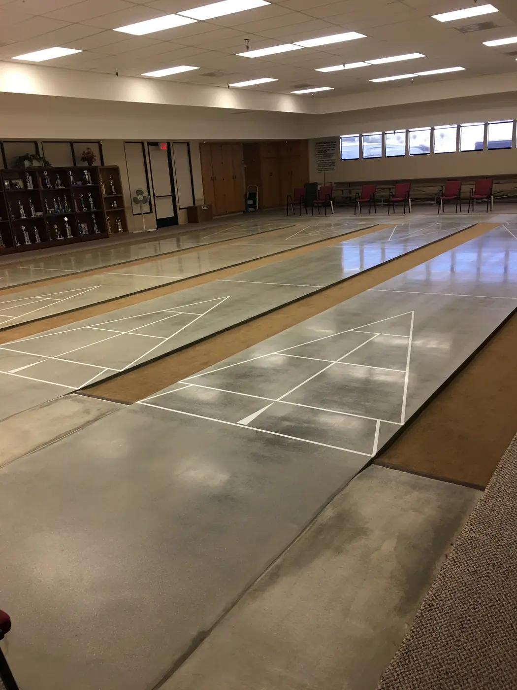 Polished concrete floor with white court lines in a community hall