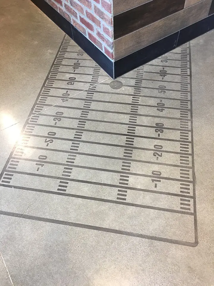 Football field graphic set into a polished concrete floor