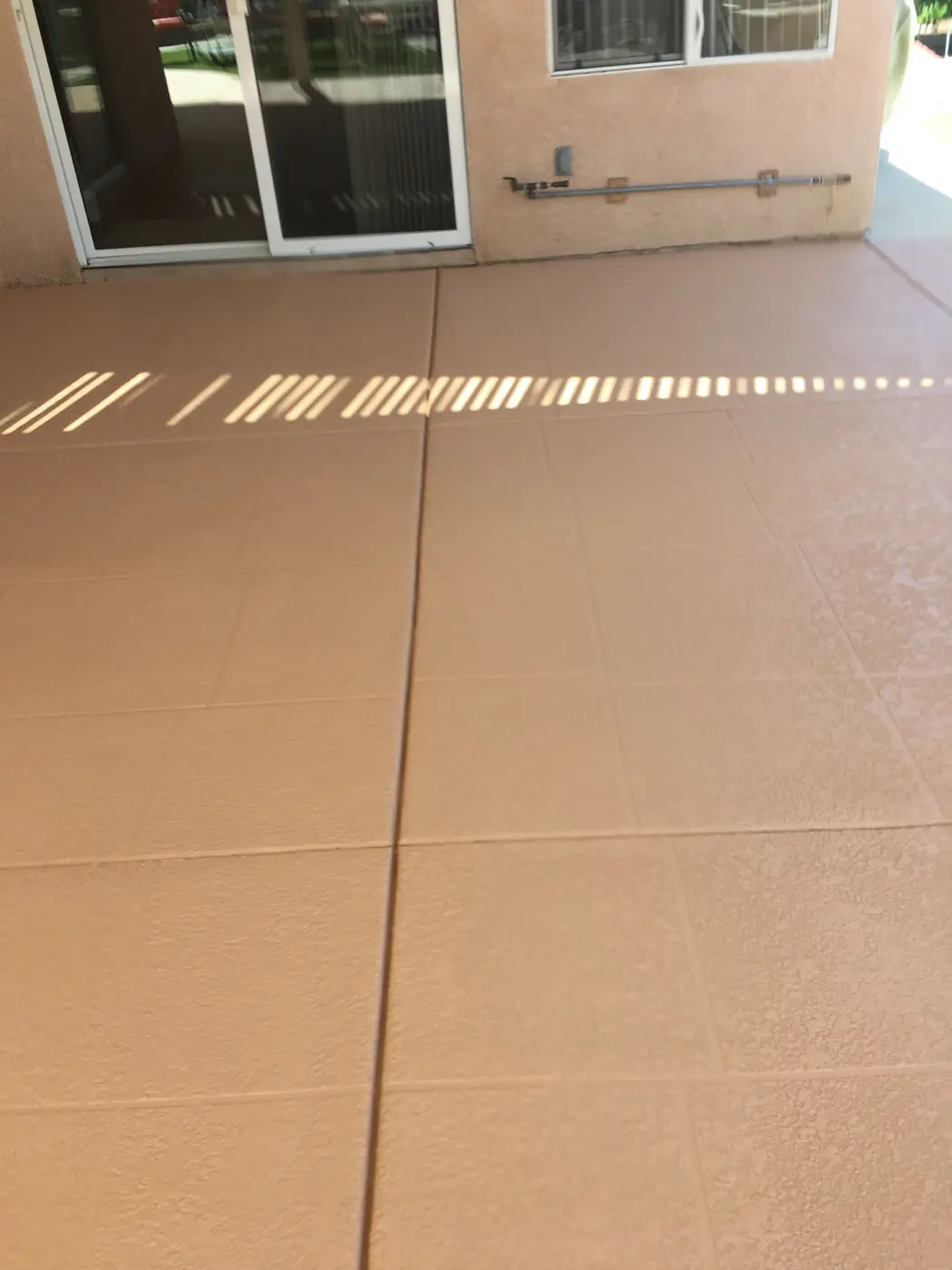 Terracotta pool deck with a clean control joint running across it