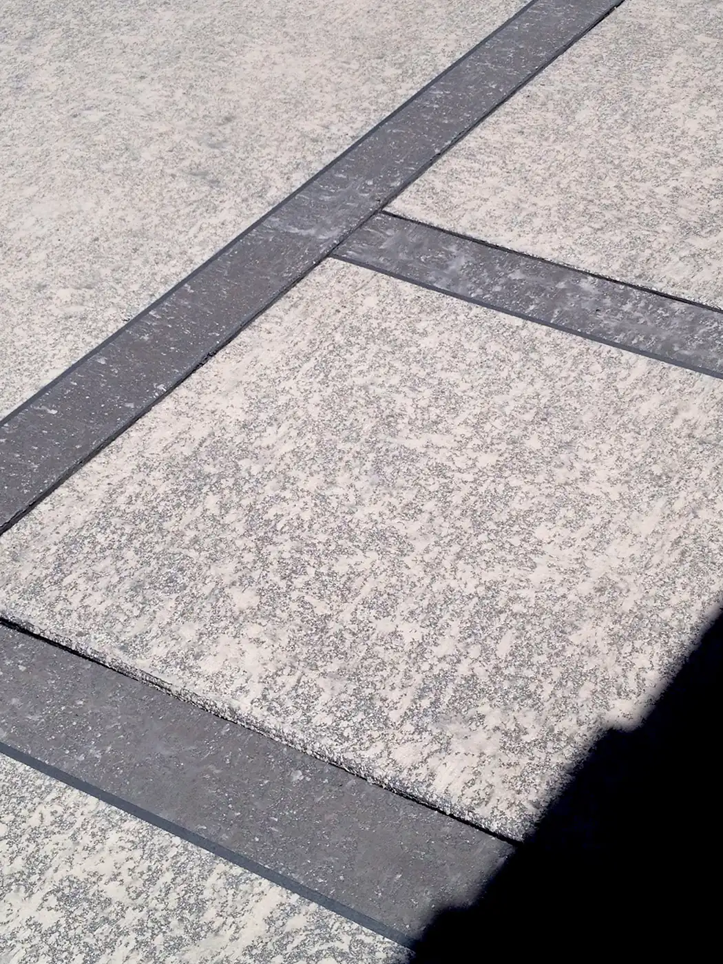 Gray knockdown textured deck framed by a dark charcoal border