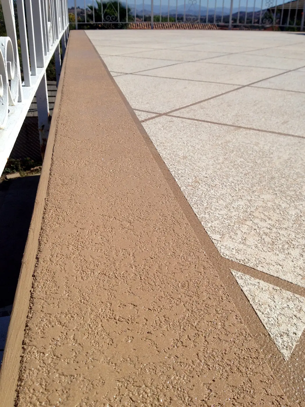 Close view of the sand texture in a tan cool deck walkway