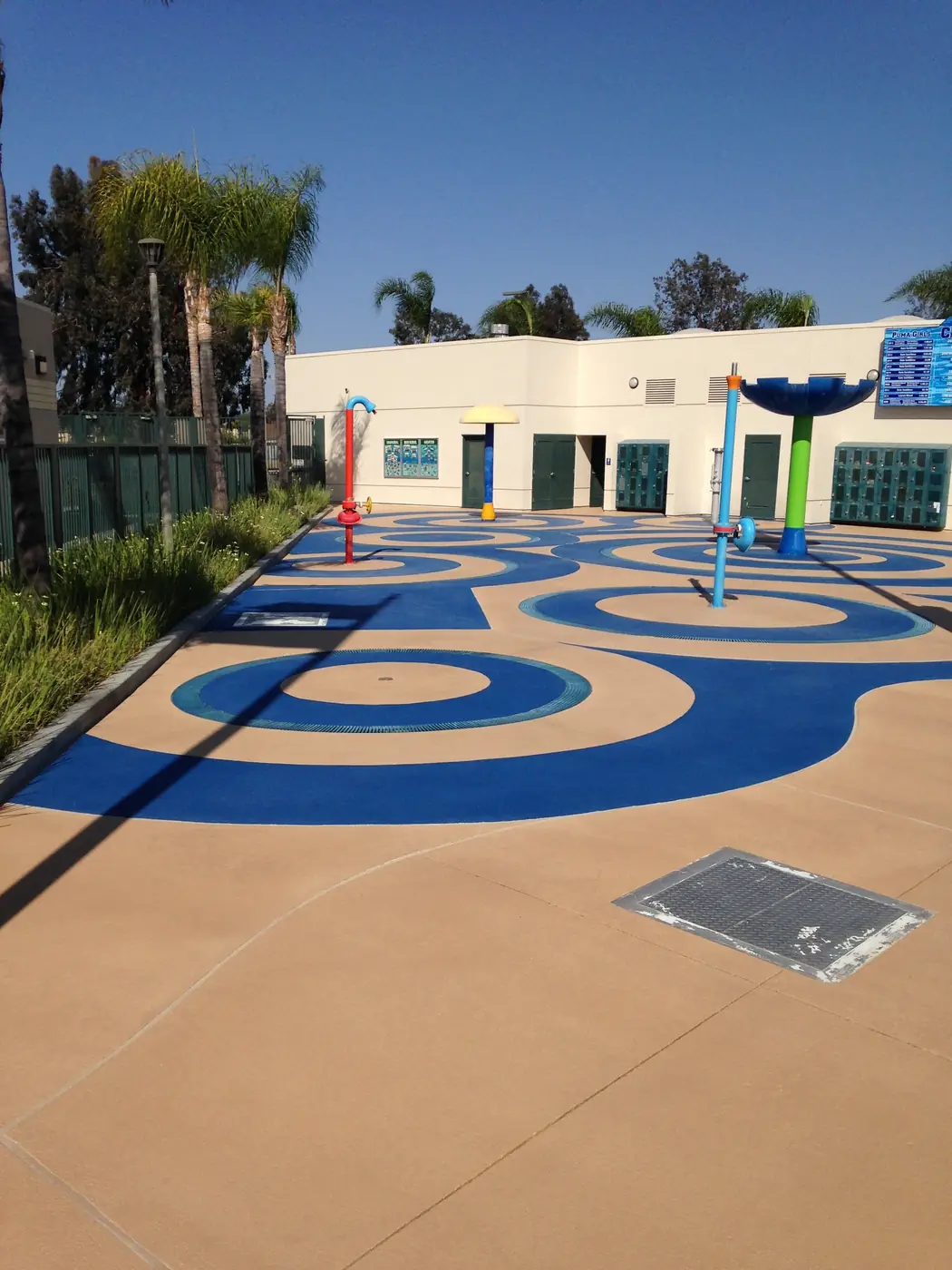 Blue swirl splash pad coating outside a school building