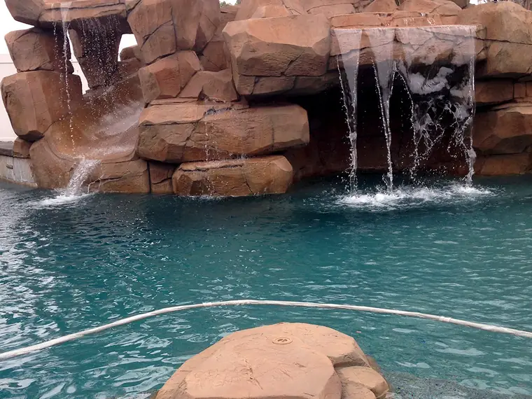 Close view of water running over restained faux rock