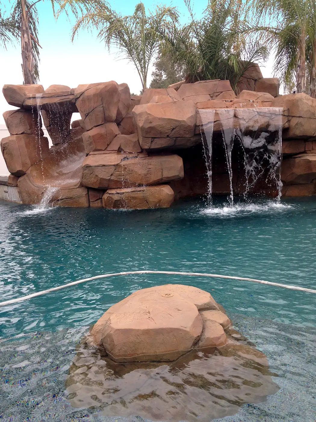 Close view of water running over restained faux rock
