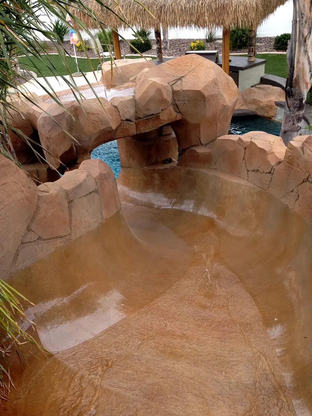Close view of restained faux rock above the waterline of a pool