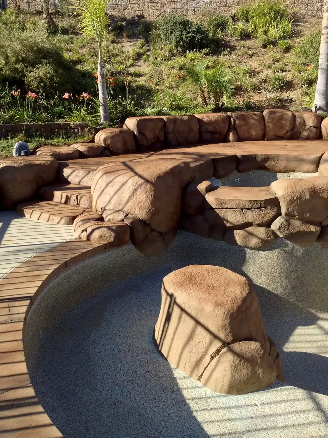 Restained rock coping and spa surround beside a pool