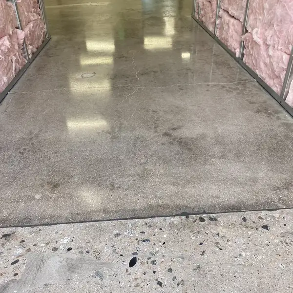 Bare concrete floor ground clean in a room lined with insulation