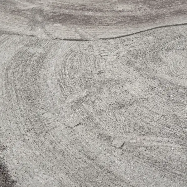 Swirl pattern left in a concrete slab by the grinder after coating removal