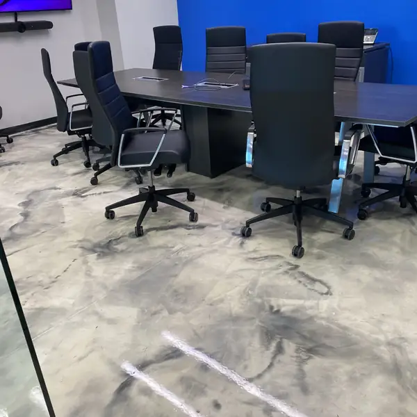 Conference room with a marbled metallic epoxy floor and a blue accent wall