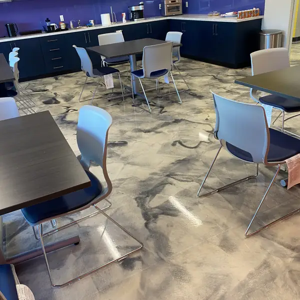 Office break room with navy cabinets standing on a marbled metallic epoxy floor