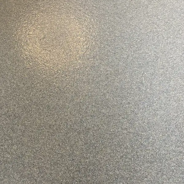 Close view of gray and black flake broadcast into a clear epoxy topcoat