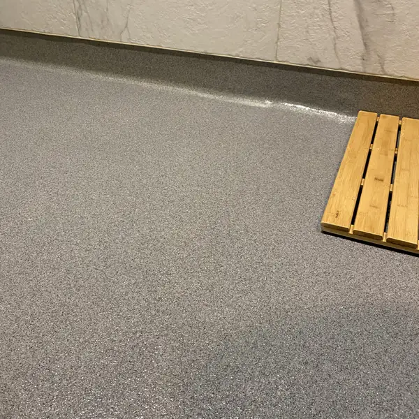 Gray flake epoxy floor beside a stacked timber pallet