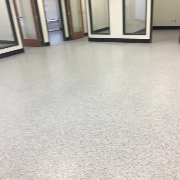 Light gray flake epoxy floor in a showroom stacked with window frames