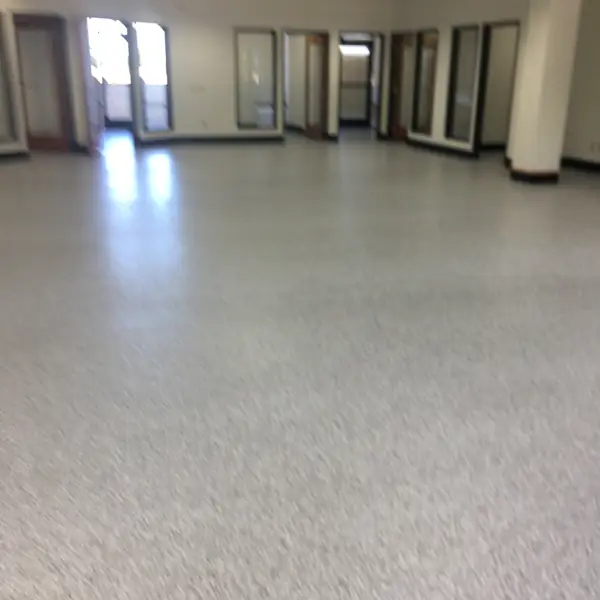 Light gray flake epoxy floor running through an empty open office