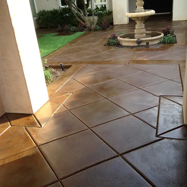 Stained courtyard in a large tile pattern around a stone fountain