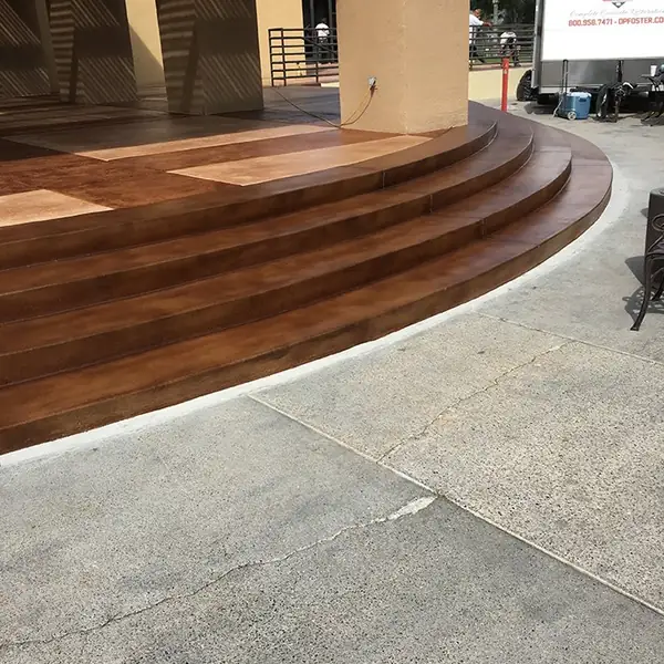 Curved entry steps stained to a wood-plank look